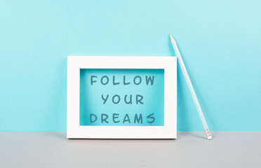 The phrase follow your dreams is standing in the frame, choaching concept, positive and optimistic...