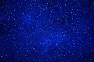 Starry night sky background.  Blue galaxy space with glowing stars.  