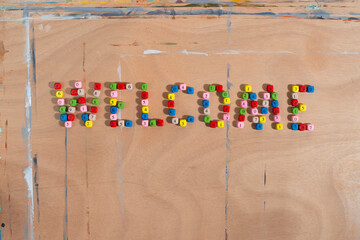 Word Welcome made of colourful number beads on wooden background. Back to school concept. 