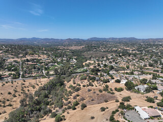 Aerial view of dry valley and land with houses and barn in Escondido, San Diego, California