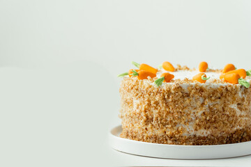 Delicious carrot cake decorated with mastic sweet carrots. Homemade carrot cake with yellow crumbs...