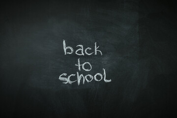 Background of the black school board with the text back to school. Chalkboard. Start of the school year concept