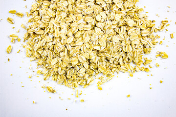 Oat flakes, breakfast on an isolated background. Natural oatmeal flakes white background.