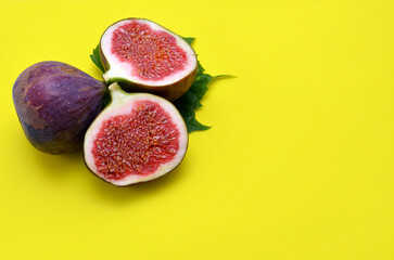 purple figs on yellow background close up
