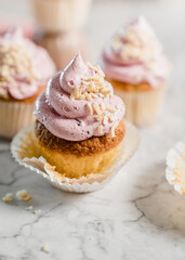 Obraz na płótnie Canvas cupcakes with whipped butter cream blackberry strawberry lemon cake