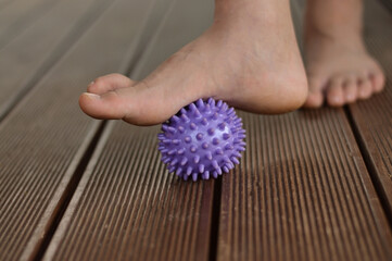 Myofascial relaxation of the muscles of the foot with a massage ball at home, close-up.