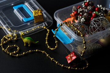Plastic container with Christmas and New Year toys and decorations. Concept of winter holidays and...