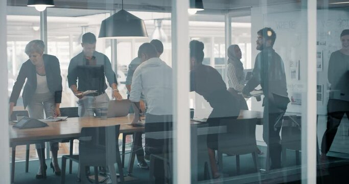 Presentation, growth and marketing meeting as a group of colleagues leave after finishing planning a strategy in the boardroom. Motivated businesspeople looking happy after successful negotiation