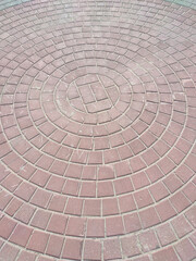 the area laid out in a circle with cobblestones beaten from time