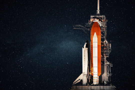 Space shuttle stands at the base and prepares to launch against the background of the starry sky. Space rocket, concept