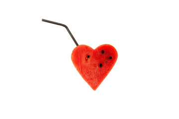 Piece of watermelon in the shape of heart with drinking straw. Concept of seasonal refreshing drinks and cocktails made from fresh watermelon pulp