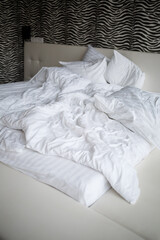 Bed with soft pillows and white sheets. White bed set