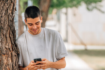 young man in the street with mobile phone or smartphone