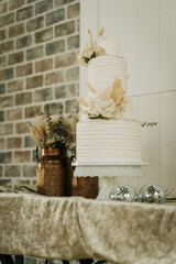 wedding cake with pampas and floral boho themed white