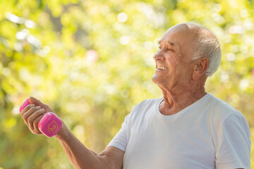 senior man doing sport or exercise outdoors with dumbbells