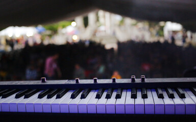 Piano keys stage view festival blurry crowd background