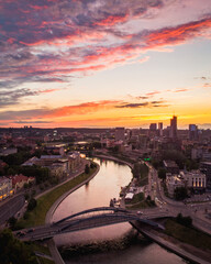 Neris river with Mindaugas bridge view and business district buildings in Lithuania capital Vilnius at scenic sunset in summer