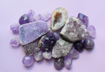 Gemstone minerals on a white background. Round tumbling minerals of amethyst and amethyst crystal.