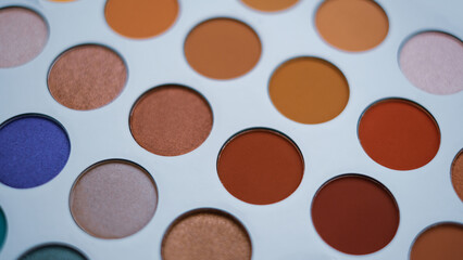 Selective focus of eyeshadow palette with various colors in pearly and matte closeup