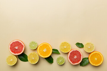 Fruit background. Colorful fresh fruits on colored table. Orange, lemon, grapefruit Space for text healthy concept. Flat lay, top view, copy space