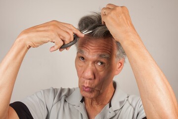 Man trying to cut his hair