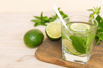 Mojito cocktail. Refreshing mojito cocktail with lime, lemon and mint in a tall glass with a stick
