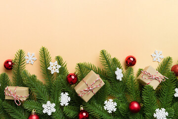 Christmas decorations and fir tree branch and gift boxon dark table. Top view frame with copy space