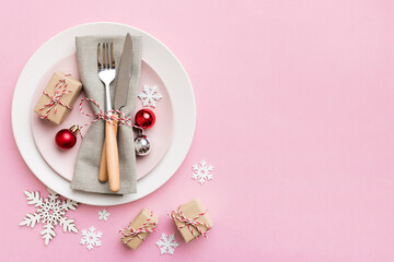 Christmas table place setting with christmas decor and plates, kine, fork and spoon. Christmas...