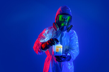 A laboratory worker presents a container with a dangerous substance.
