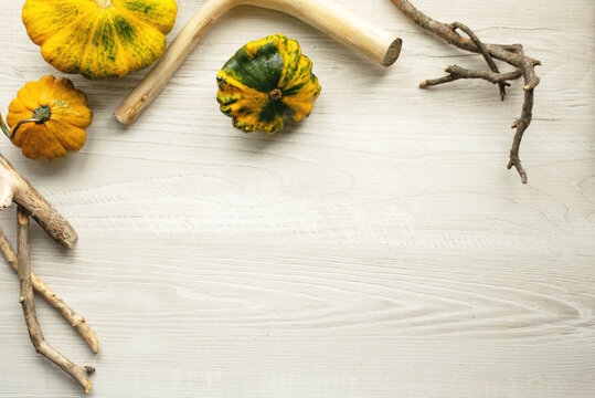 Autumn still life with pumpkins on a table with free space for your text, top view. Visual picture.