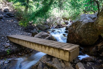 Long exposure of a waterfall with a small wooden bridge