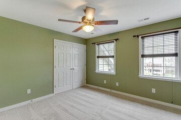 empty room with a window green wall traditional light fixture