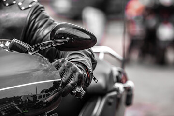 Hand on the wheel. Heavy motorcycle. Leather biker glove. Protective equipment of a motorcyclist.