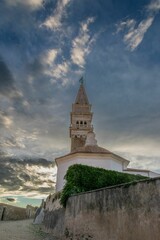 Vertical low-angle view of the St. George's parish church under the cloudy sky