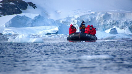 Fototapeta na wymiar Zodiac inflatable boat navigating among icebergs in Cierva Cove, Antarctica