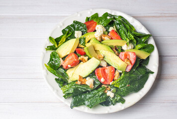 Healthy diet salad; Strawberry Spinach Salad with Avocado.