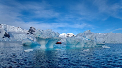 Zodiac inflatable boat navigating among icebergs in Cierva Cove, Antarctica