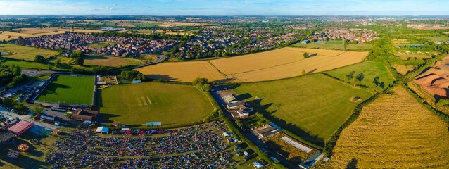 Aerial panoramic view of crowded Mickleover during music festival in England