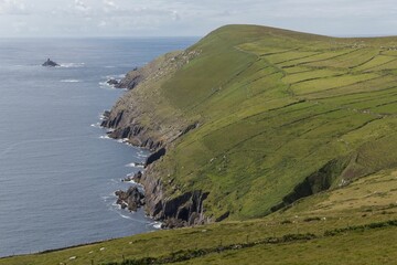 View of a coastal green cliff