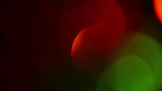 Christmas bokeh motion. Red and Green defocused circles shimmer, shine and sparkle. Festive relaxing video. Can be used as background, overlay or New Year screen for your apps.