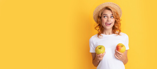 Summer girl hold apple. cheerful redhead woman in straw hat hold apple licking lips, dietary. Woman isolated face portrait, banner with mock up copy space.