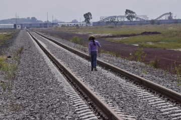 girl walks on the tracks
