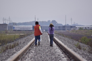 girl walks on the tracks
