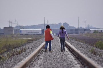 girl walks on the tracks

