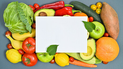 Creative copy space with paper and healthy fruits and vegetables on grey background. Healthy lifestyle concept. Flat lay