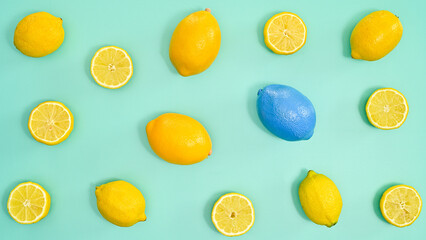 Summer lemons pattern on cyan background. Tropic fruits concept. Flat lay