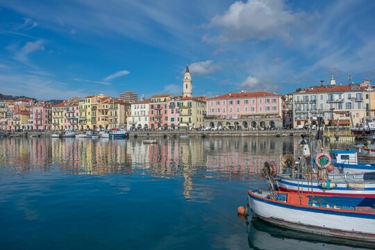Aerial view of Ligurian coast surrounded by buildings under blue bright sky in Italy