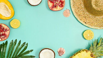 Summer tropic frame made with exotic fruits on pastel tirquoise background. Flat lay.
