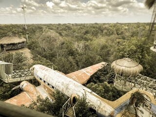 View of a crashed airplane in the forest on a cloudy day in Cancun, Mexico
