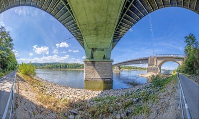 Wide angle view of a highway bridge from below with symetric geometries